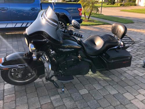 all black custom motorcycle with windshield and passenger seat